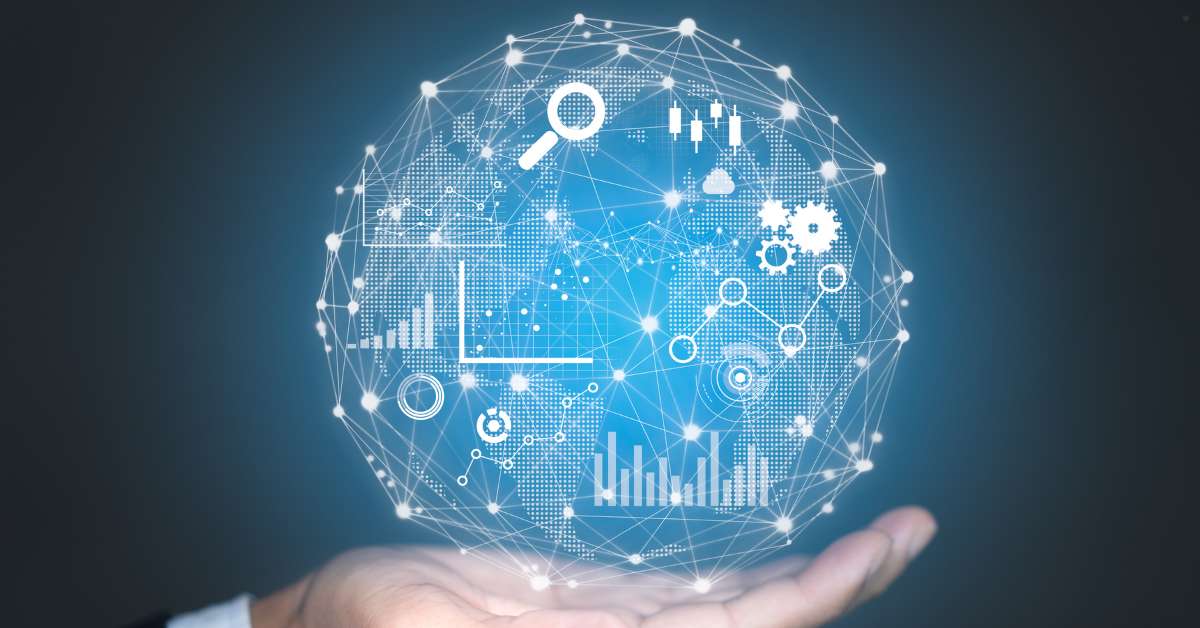 A hand holds up a glowing, blue-hued sphere, which is a stylized globe made of interconnected white lines. The globe is covered with various icons and charts representing data analytics, including bar graphs, line graphs, magnifying glasses, and cogs.